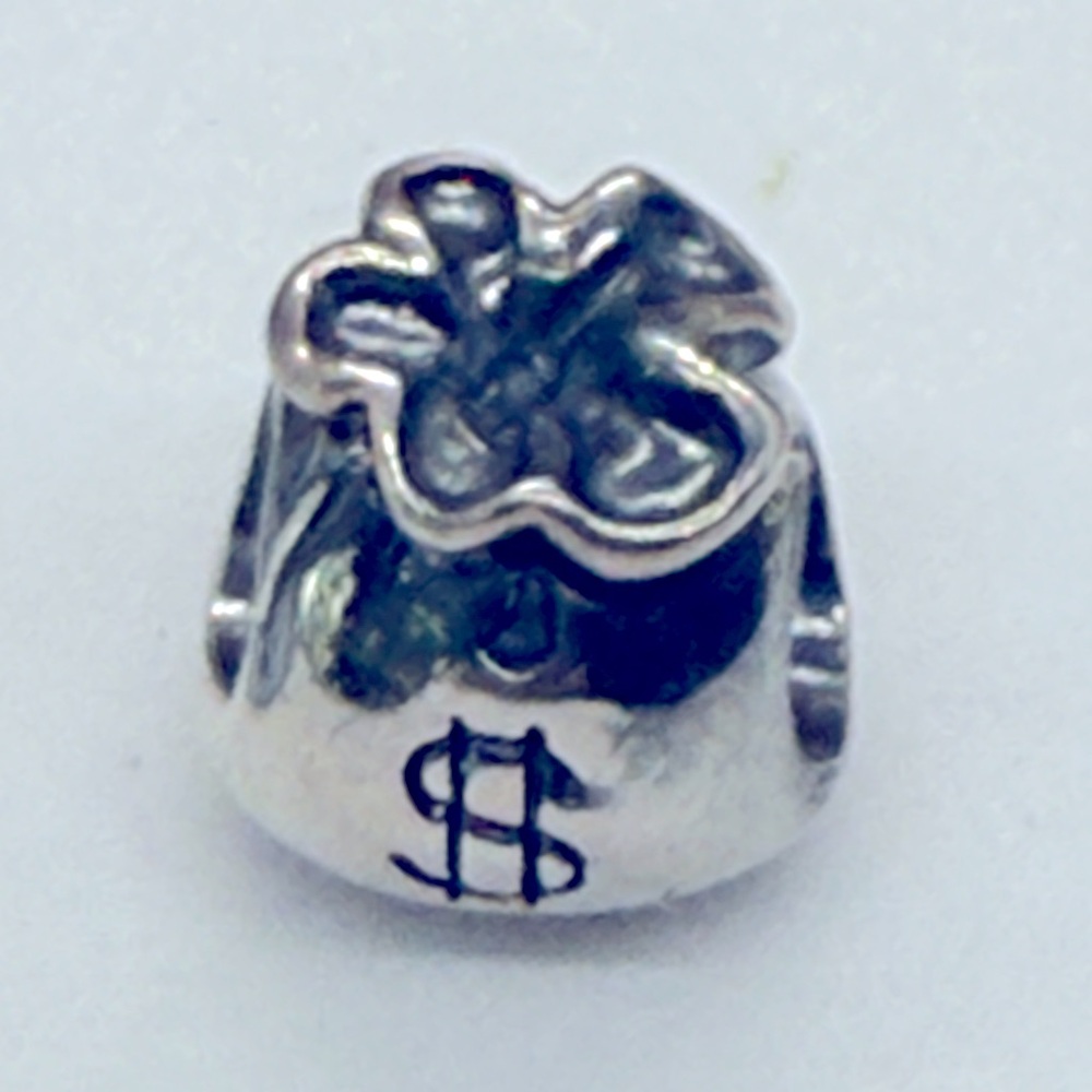 This is an authentic Pandora sterling silver charm in the shape of a money bag.